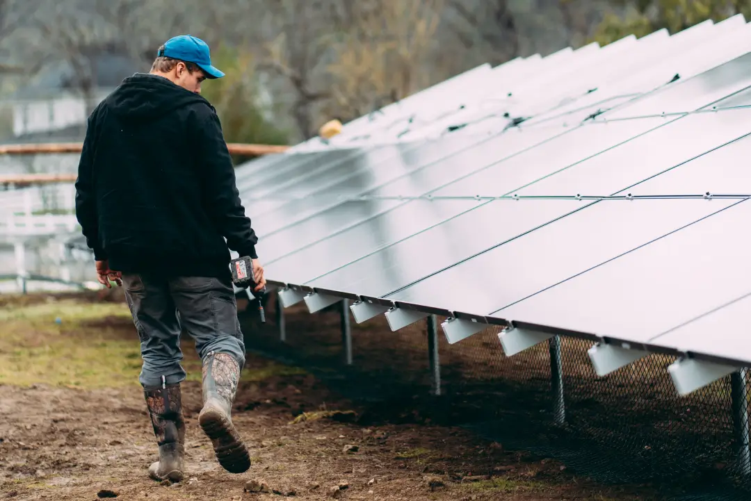 2 solar panel installers on the roof installing panels