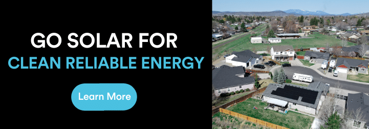 next to an aerial view of a house in Oregon with solar installed on its roof, we see a black background with the words "Go solar for clean, reliable energy" written in white and bright blue. Below the words is a bright blue button with the words "learn more" in white.