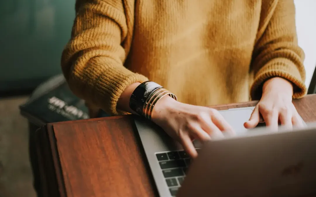 woman using her apple laptop